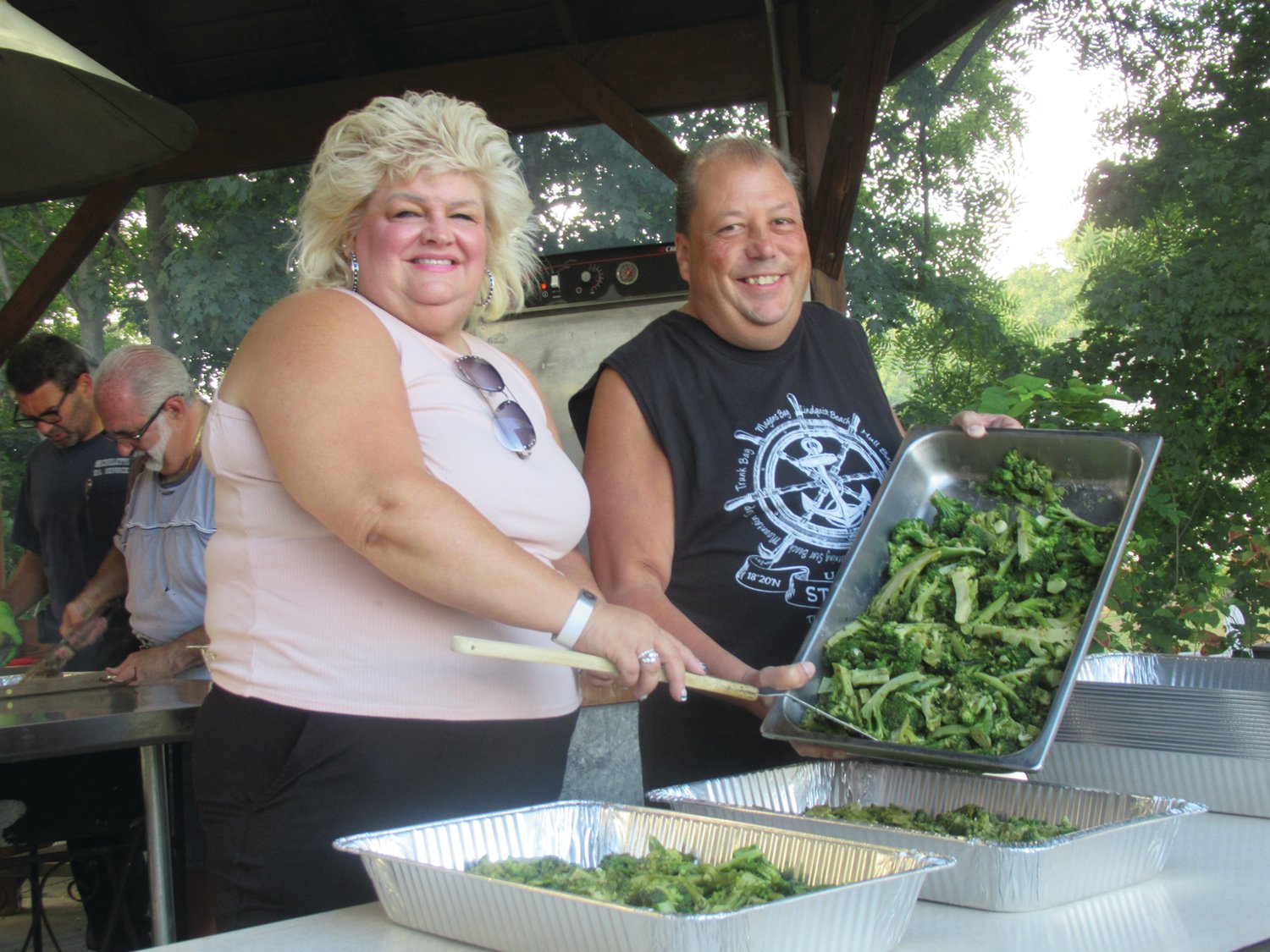 DELICIOUS DISH: Michelle Lanciaux and Jacob Whitford scoop heaping pans filled with freshly cooked broccoli that people enjoyed Saturday night at OLG in Johnston.